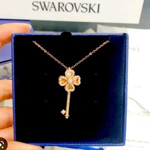 Beautiful rose gold Swarovski crystal “swirling clover key” pendant.